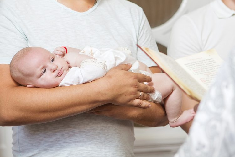 baby being held by father